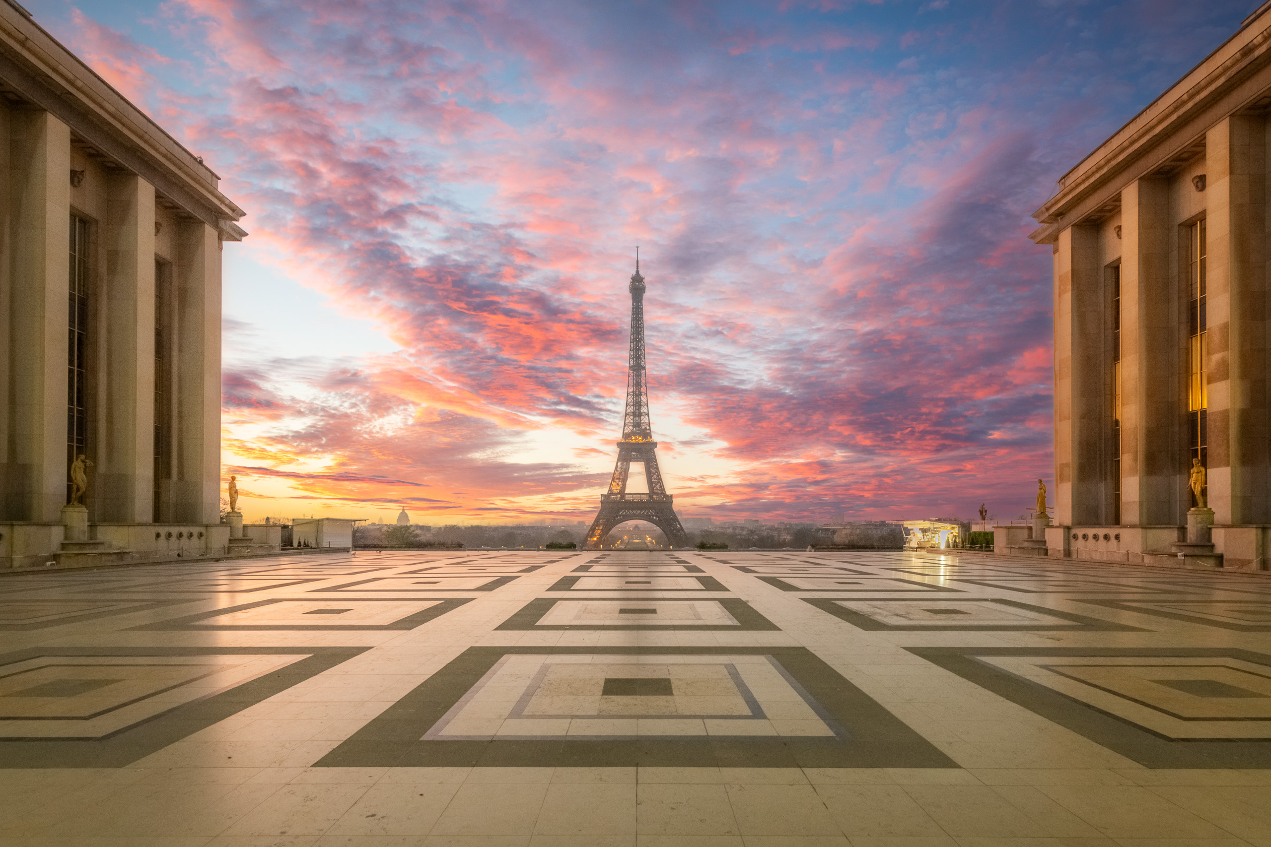 Horizontal sunrise photograph of the Eiffel Tower from the Trocadéro Plaza in Paris