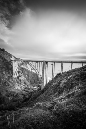 Bixby Creek Bridge in Big Sur California spanning coastal canyon in dramatic black and white landscape