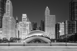 Black and white horizontal photograph of Cloud Gate Bean reflecting the Chicago skyline in Millennium Park