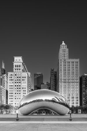 Black and white vertical photograph of Cloud Gate Bean sculpture in Millennium Park Chicago