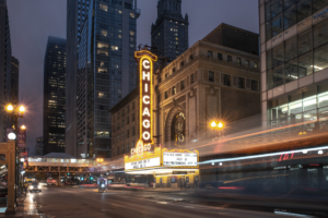 Horizontal night photograph of the Chicago Theatre marquee with motion light trails in downtown Chicago