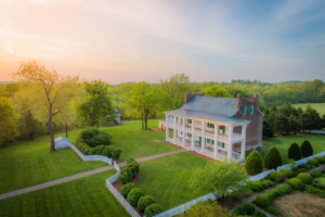 Aerial view of Carnton Plantation at sunset in Franklin, Tennessee, showcasing the historic antebellum home and beautifully landscaped grounds.