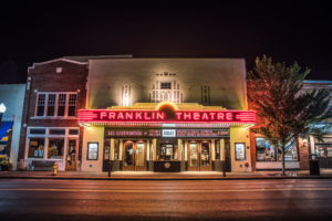 The historic Franklin Theatre illuminated at night on Main Street in downtown Franklin, Tennessee.