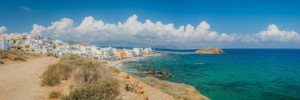 Panoramic coastal view of Naxos Greece with white buildings, turquoise sea, and dramatic clouds