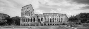 Panoramic black and white photograph of the Colosseum in Rome Italy under dramatic clouds