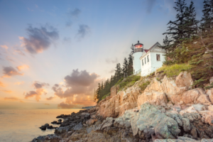 Bass Harbor Head Lighthouse at sunrise on the rocky cliffs of Acadia National Park, Maine