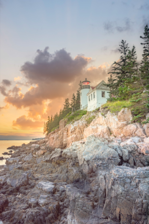 Bass Harbor Head Light lighthouse on rocky coast at sunrise in Maine