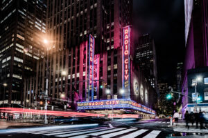 Radio City Music Hall glowing with neon lights at night in New York City