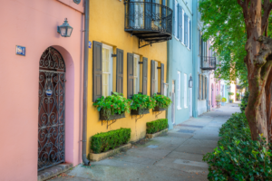 Colorful pastel homes with shutters and window boxes along Rainbow Row street in Charleston South Carolina