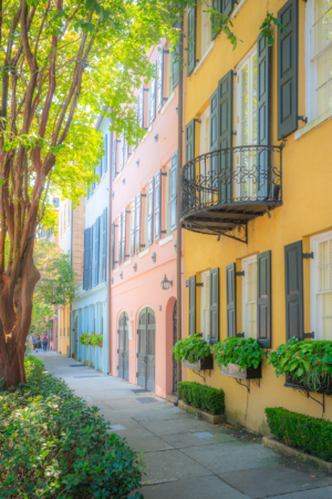 Pastel historic homes with shutters and balconies along Rainbow Row street in Charleston South Carolina