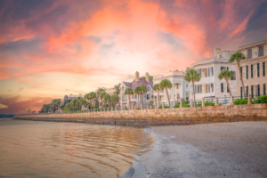 Sunset over historic waterfront homes and palm trees along Charleston Battery in South Carolina