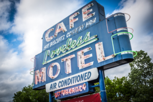 Vintage neon sign for Loveless Cafe Motel in Nashville Tennessee against cloudy sky