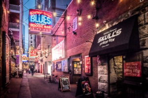 Printers Alley in downtown Nashville Tennessee at night with neon lights and music clubs