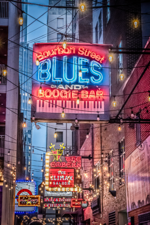Neon signs glowing in Printers Alley at night in downtown Nashville Tennessee