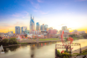 Nashville Tennessee skyline at sunset over the Cumberland River with city reflections
