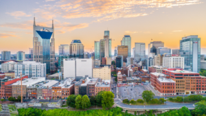 Nashville Tennessee downtown skyline at sunset with glowing sky and city buildings