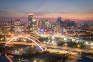 Nashville Tennessee sunset skyline with illuminated bridge and downtown city lights