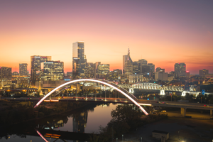 Nashville Tennessee skyline at sunset with illuminated bridges over the Cumberland River