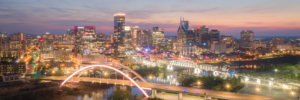 Nashville Tennessee skyline at sunset with illuminated bridges and city lights panorama
