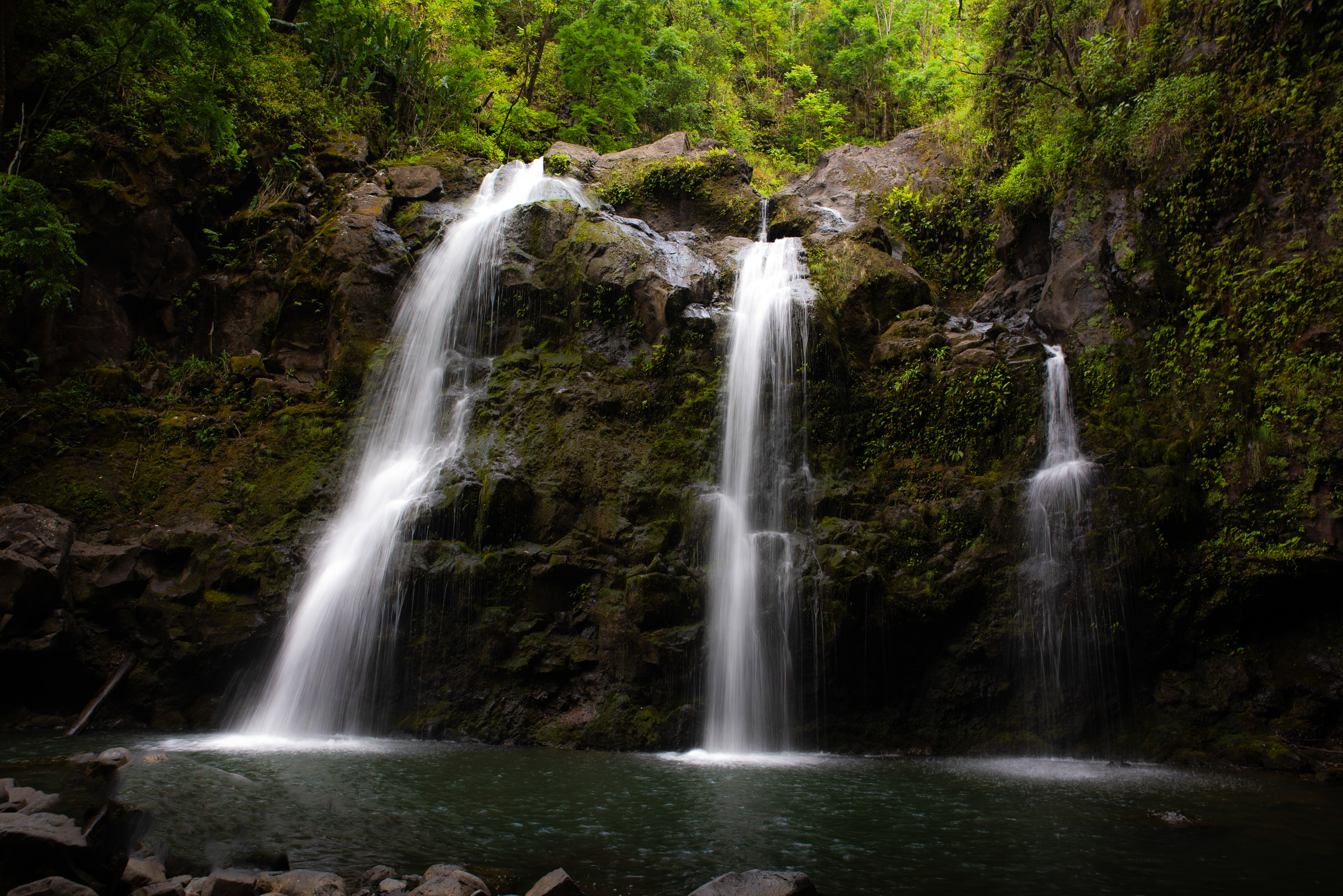 Upper Waikani Falls cascading into pool in lush Maui rainforest along the Road to Hana Hawaii