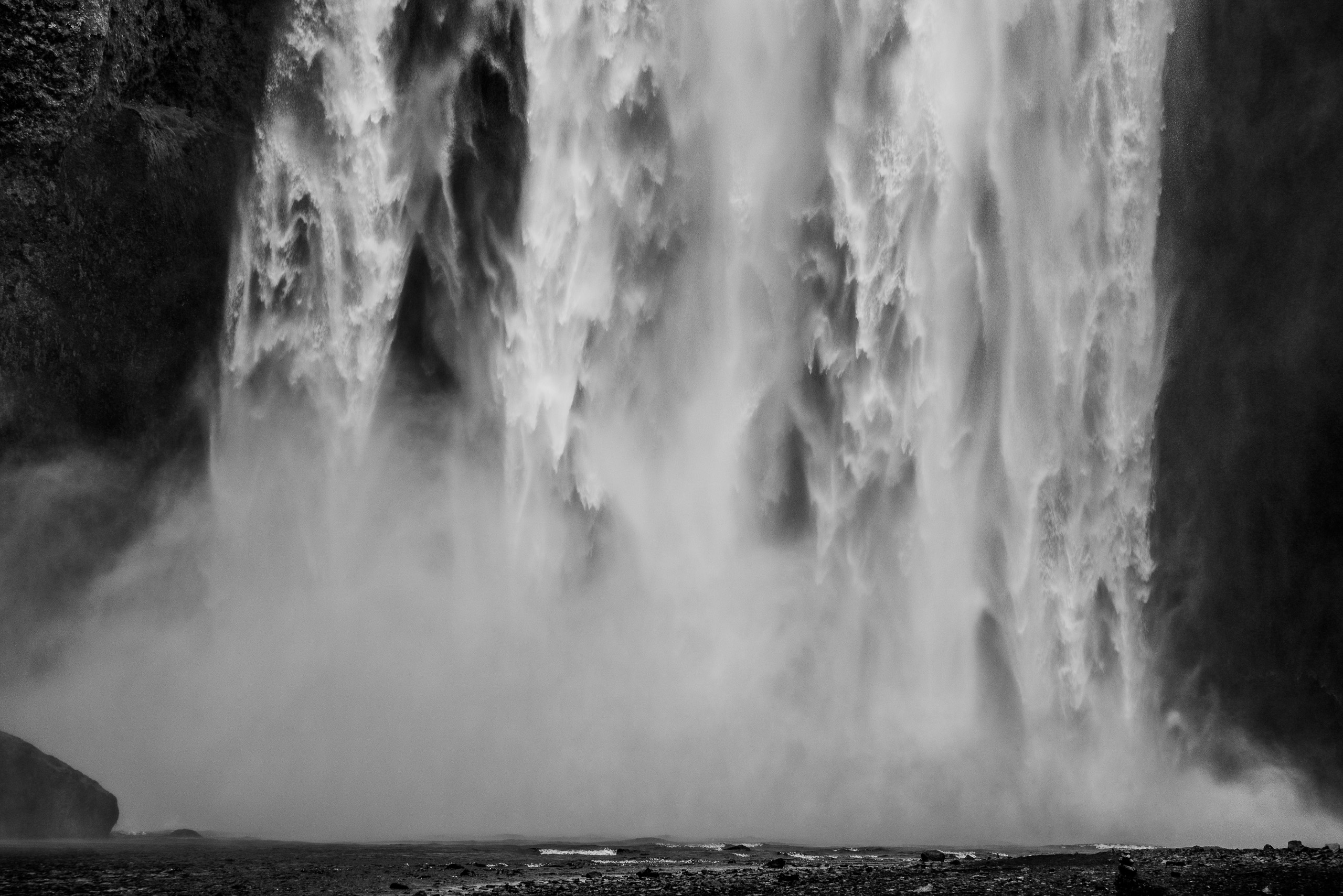 Black and white close view of Skogafoss waterfall with cascading water and mist in Iceland