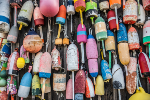 Close-up of colorful lobster buoys hanging on a wall in Maine
