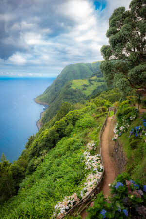 Scenic coastal trail overlooking green cliffs and ocean in the Azores Portugal