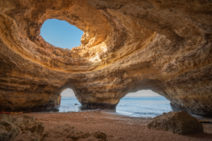 Interior of Benagil Cave with skylight opening and ocean view in Portugal