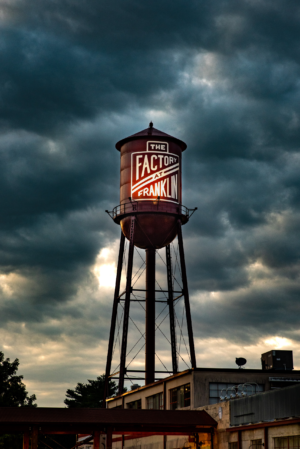 The Factory at Franklin water tower in Franklin Tennessee under dramatic cloudy sky
