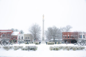 Historic downtown Franklin Tennessee town square covered in fresh snow with monument and cannons
