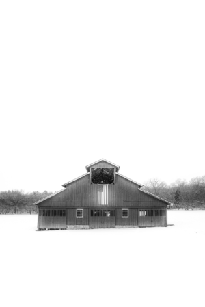 Black and white photograph of the historic Hillsboro Road barn surrounded by snow in Franklin, Tennessee
