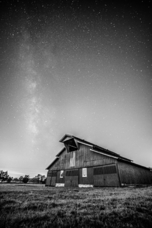 Black and white photograph of a historic barn beneath the Milky Way on Hillsboro Road in Franklin, Tennessee
