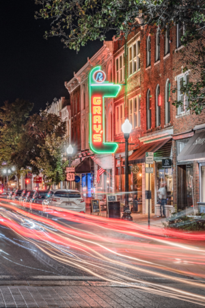 Vertical long exposure photograph of Main Street in downtown Franklin, Tennessee, featuring the illuminated Gray’s on Main sign and car light trails