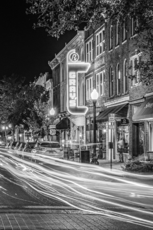Black and white long exposure photograph of Main Street in downtown Franklin, Tennessee, featuring the illuminated Gray’s on Main sign and light trails