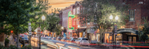 Panoramic long exposure photograph of downtown Franklin Tennessee featuring Gray’s on Main and light trails at sunset