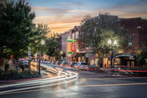 Long exposure photograph of Main Street in downtown Franklin, Tennessee, with car light trails at sunset