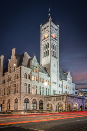Vertical photograph of the historic Nashville Union Station Hotel at twilight with long exposure light trails in downtown Nashville Tennessee