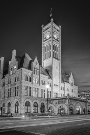 Black and white photograph of the historic Nashville Union Station Hotel and clock tower at night in downtown Nashville Tennessee