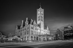 Black and white photograph of the historic Nashville Union Station Hotel at night with long exposure light trails in downtown Nashville Tennessee