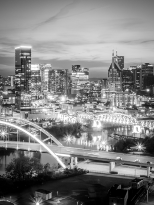 Black and white photograph of the downtown Nashville skyline and Cumberland River at night in Nashville, Tennessee